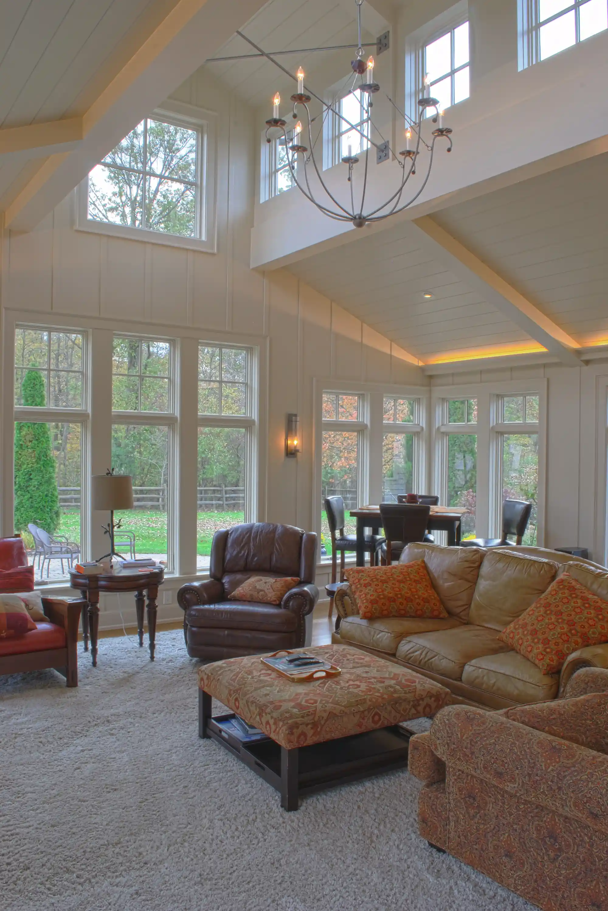 Living room showing vaulted ceiling with chandelier