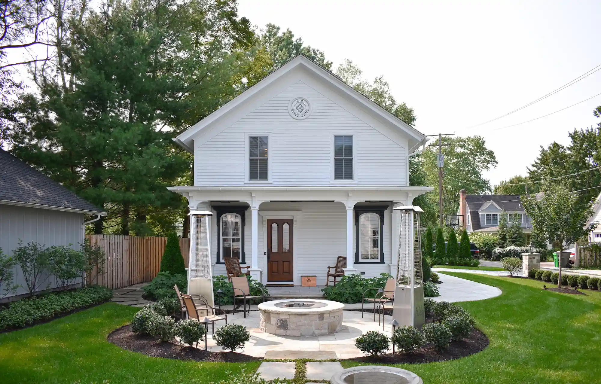 Straight on front view of the front of the house with the seating area/fire pit directly in front