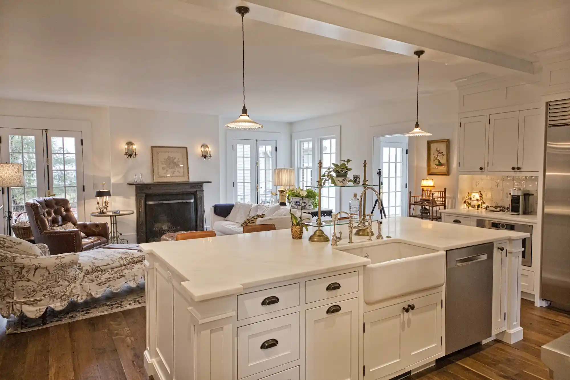 Kitchen island in foreground with sitting area beyond